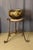 Wrought iron tripod stand with marble top. Early 20th century. DIMENSIONS: 0.78m high, 0.80m wide base, and 0.45m diameter...