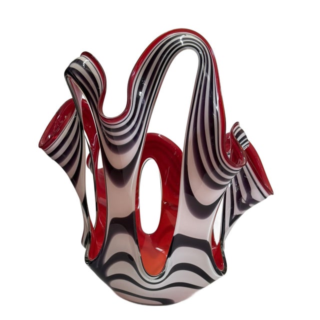 The dramatic glass object is Jozefina, a hand-blown premium art glass line produced by the Krosno glassworks in Poland,...