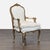 This beautiful vintage armchair features a classic wood frame with ornate gold trim and soft white upholstery. The...