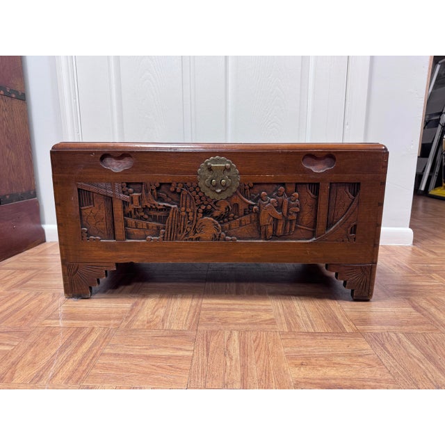 A charming, compact Hong Kong camphor chest from around the 1950s. It's deeply carved on all four sides and the lid, with...