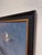 This oil on panel depicts a serene night scene by the beach, where gentle waves crash against rocky outcrops under a moody...
