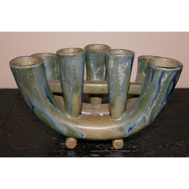 A really beautifully glazed candle holder out of a collection of wonderful art pottery. It has a collection sticker on...