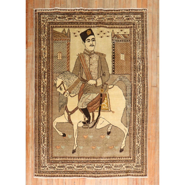 An early 20th Century Persian Tabriz rug with a Persian man riding on his horse. 4' x 5'8''