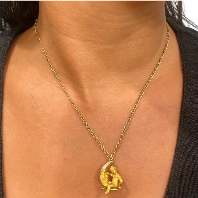 Carrera Y Carrera 18K yellow gold necklace, featuring a moon's face & child pendant with satin finish. The moon is...
