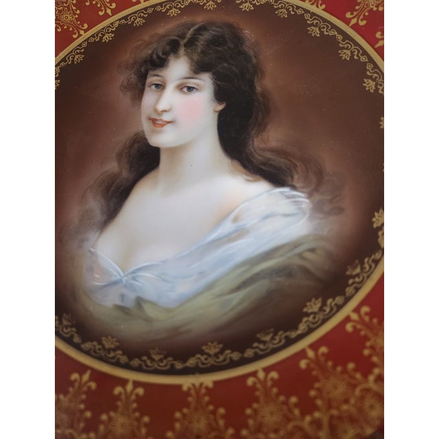 This is a Royal Vienna (Austria-Poland) porcelain portrait cabinet plate in the "Amicitia" pattern. The plate features a...