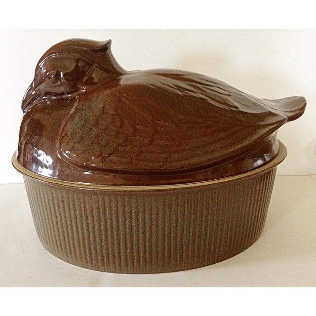 Purbeck pottery English tureen of a duck sitting in a basket. The rich brown glaze has hints of green washed in on the...