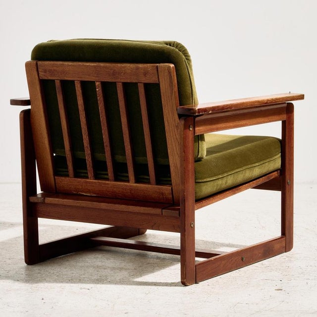 Hungarian beech armchair from the 1960s with upholstered seat and back cushions. The surface of the furniture shows...