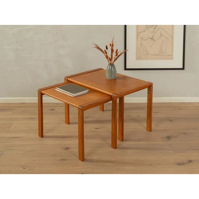 Rare nesting tables from the 1960s. High-quality solid teak frame and table top in teak veneer with solid wood edge....