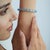 This 26.1 Ct Blue Topaz Tennis Bracelet features a continuous row of octagon-cut gemstones in a polished 925 sterling...
