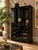 A striking vintage armoire by Broyhill, featuring a dramatic high-gloss black lacquer finish, Asian-inspired architectural...