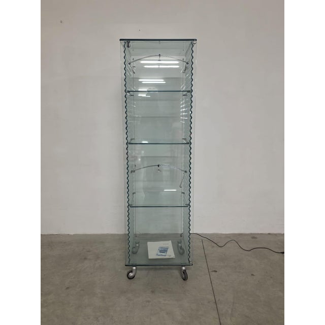 Onda series display cabinet by Ron Arad for Fiam. Elegant, caster-style cabinet made entirely of glass. The sides feature...