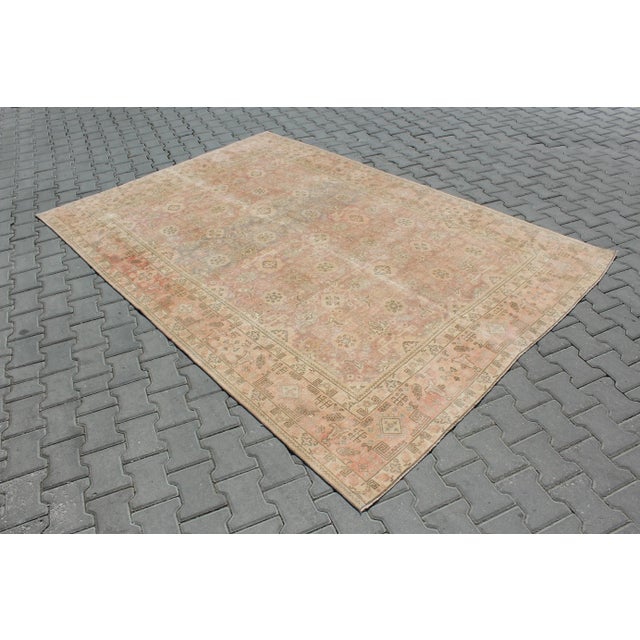 This beautiful, traditional vintage, hand knotted Turkish area rug is approximately 60 years old. It is handmade of very...