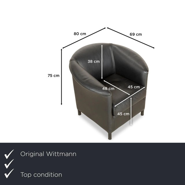 The Aura armchair by Wittmann is upholstered in black genuine leather and stands on black legs. It is characterized by its...