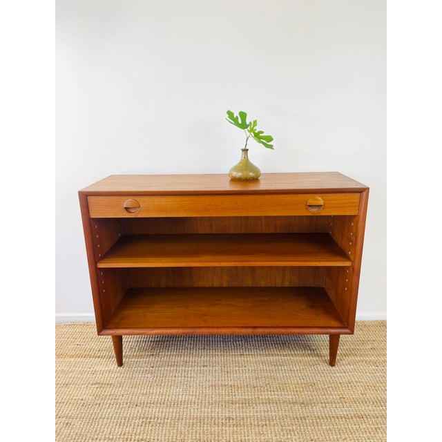Vintage 1960s Danish Modern Teak Cabinet sleek mid-century modern design made of teak wood slim top drawer with round...