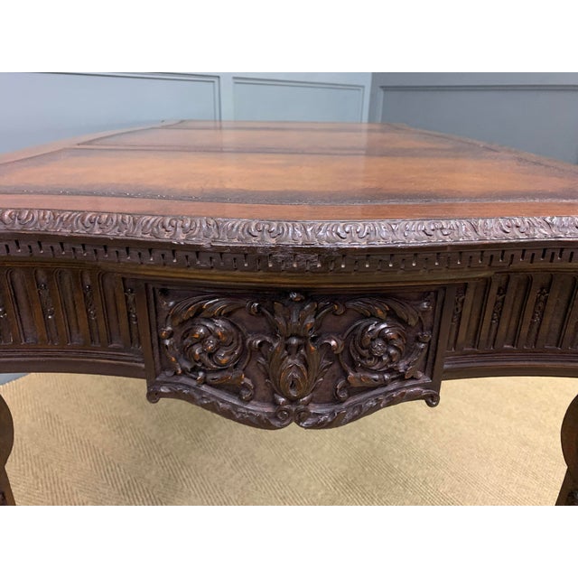 A bold and impressive carved mahogany writing table in the manner of Thomas Chippendale. Of generous proportions, made and...