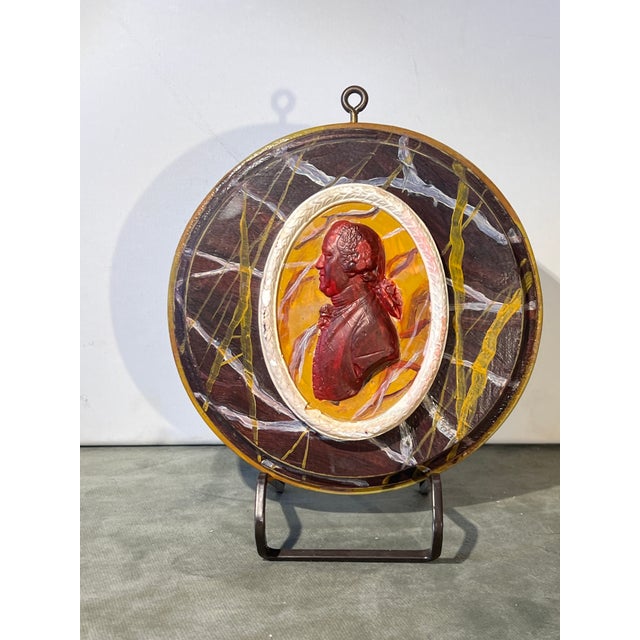 This piece is a decorative portrait medallion featuring a profile silhouette of Josiah Wedgwood I, crafted using...
