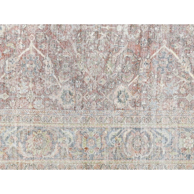 This Antique Persian Mahal Rug is a stunning addition to any space. Measuring 8'11" x 12'0", it boasts intricate designs...