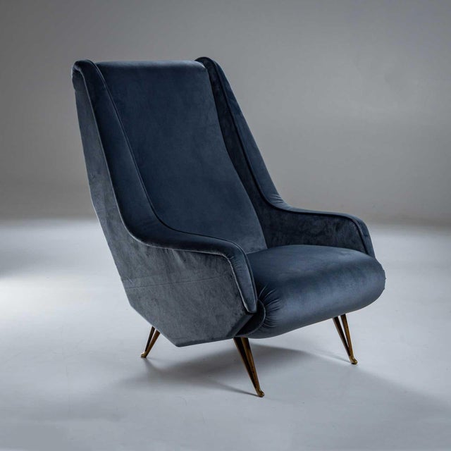 Pair of ISA Bergamo lounge chairs on forked brass legs, upholstered in blue velvet.