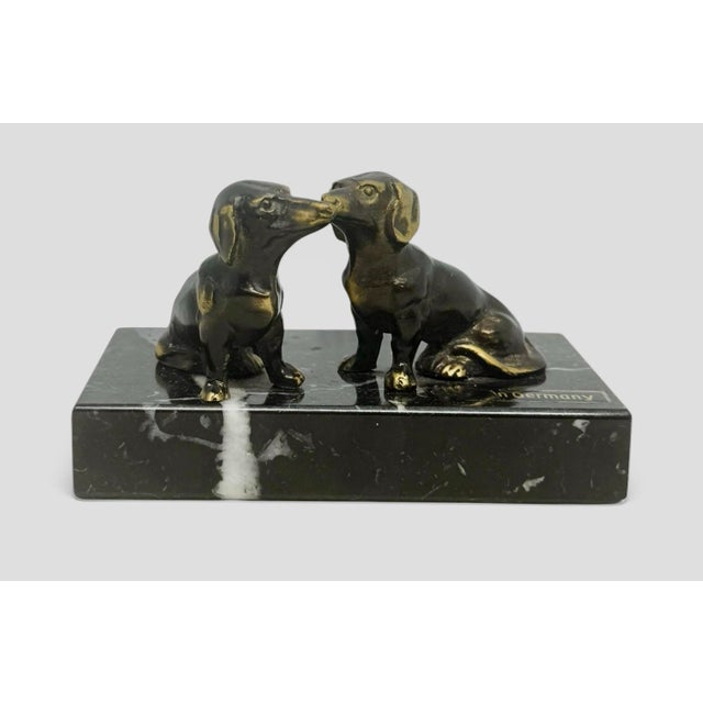 A charming vintage paperweight featuring two brass dachshunds mounted on a polished marble base. Crafted in Germany, this...