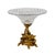 Large fruit vase made of crystal and bronze. A bright crystal flowerpot is mounted on a spiral rod formed by two swimming...