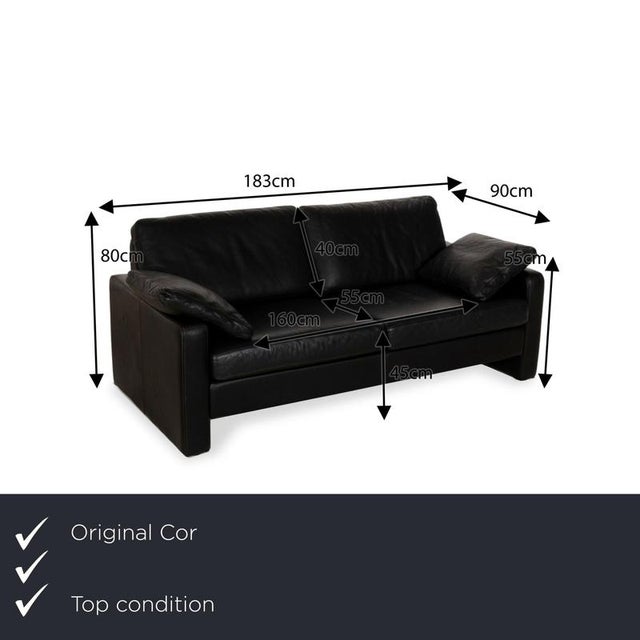 The Conseta sofa from Cor is covered in black genuine leather and stands on floor-to-ceiling side panels. The timeless,...