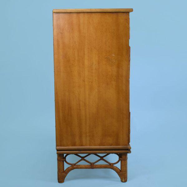 A faux bamboo tall boy chest, its tall case stacked with drawers beneath turned bamboo detailing. The vertical format is...