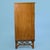 A faux bamboo tall boy chest, its tall case stacked with drawers beneath turned bamboo detailing. The vertical format is...