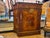 This is a French style marquetry fruitwood console table. It has a door, and shelving inside. It has a great amount of...