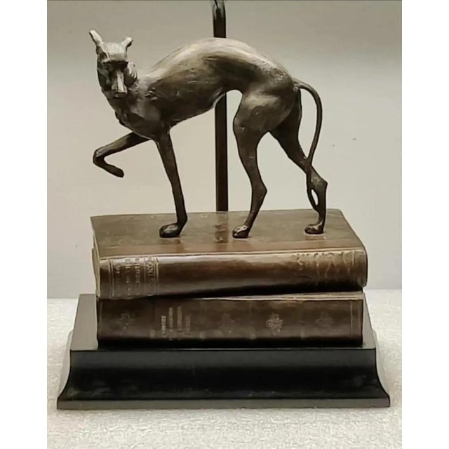 For your consideration. . . A beautiful vintage bronze Whippet/Greyhound standing on top of a stack of faux books with a...