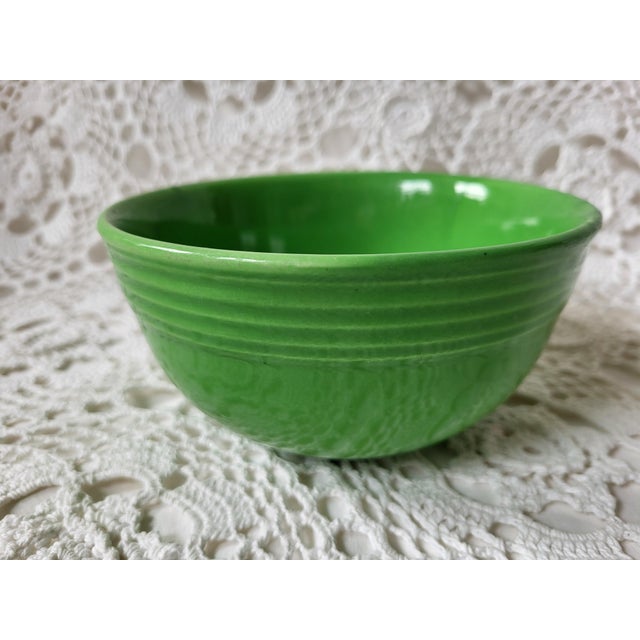 This lovely medium green bowl looks very similar to Fiestaware. It is not marked but the ribbed stripes have the signature...