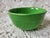 This lovely medium green bowl looks very similar to Fiestaware. It is not marked but the ribbed stripes have the signature...