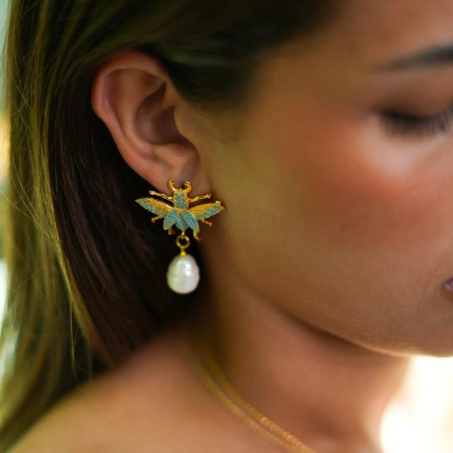 Make a bold statement with the Divine Connection Queen Bee Turquoise & Gold Chunky Earrings, crafted in 24k gold plating...