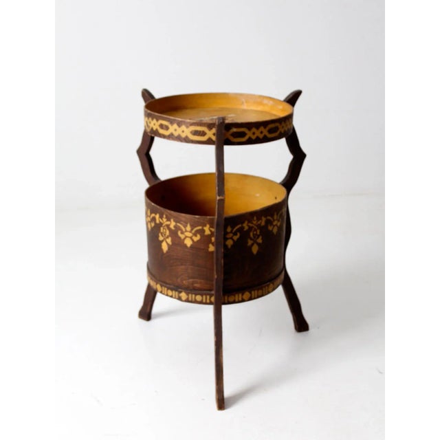 This is an antique bandbox table, a charming example of American folk art furniture. Crafted from a wooden band or cheese...