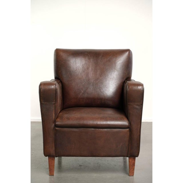 This sturdy vintage sheepskin armchair is compact in size, features a beautiful, timeless English design, and has a lovely...