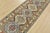 A tribal Caucasian Kazak runner hand-knotted with fine wool on a cotton foundation. This rug features a row of geometric...
