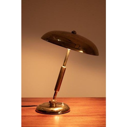 This brass table lamp from the 40s is designed for Variolux by Giovanni Michelucci. The shade can be adjusted. The lamp...