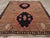 This piece features a wool pile of symmetric knots on a wool foundation. The abrashed medium brown field displays two...
