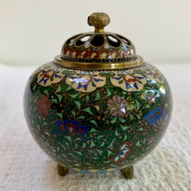 A beautifully detailed antique Japanese cloisonné censor (koro) featuring a vibrant phoenix bird amid a lush floral ground...