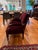 A stunning pair of American Eastlake parlor chairs, circa 1870s–1880s, featuring exquisite carved walnut crestwork, gold...