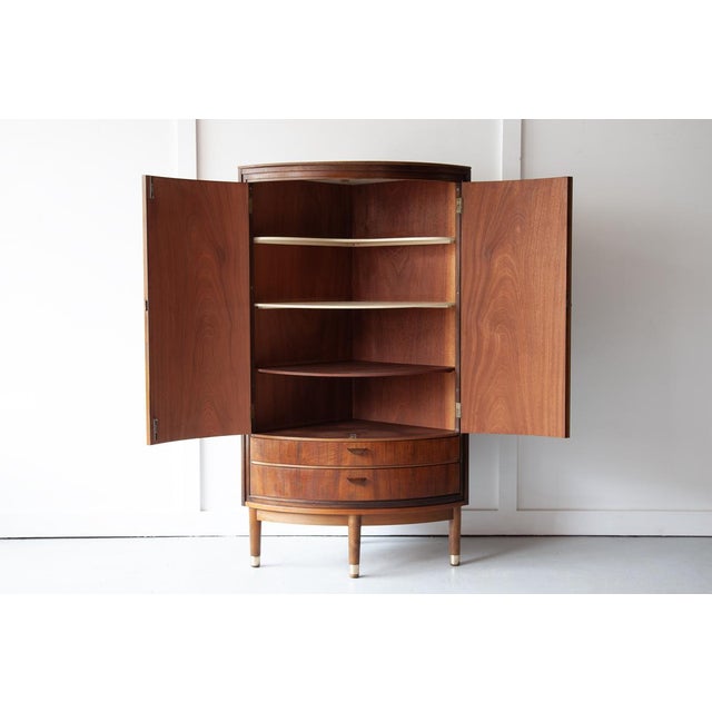 A beautiful rosewood bow-front corner cabinet, made in the 1950s by L. Chr. Larsen & Søn, and attributed to Danish...