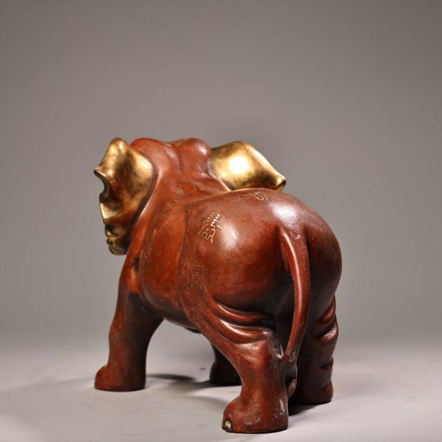 A majestic and auspicious vintage sculpture of an elephant, masterfully cast in solid copper and finished with exquisite...