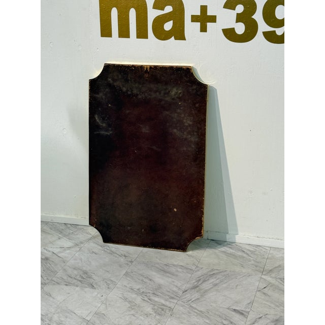 A tall, rectangular Italian wall mirror with elegant notched corners and a minimalist design. The frame is made of solid...