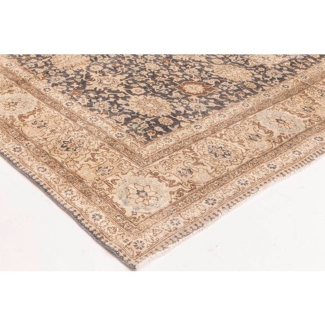 A late 19th century Tabriz Persian rug, the dark brown field with an overall Shah Abbas design with a palmette and...