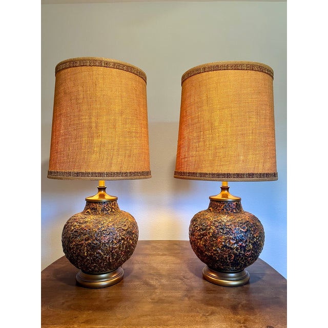 A striking matched pair of 1971 Royal Haeger ceramic table lamps, Model 7009, featuring the richly textured Orange Texture...