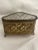 This brass plated jewelry box for a dresser is done in a basket weave pattern and is in a triangular shape with 3 feet....