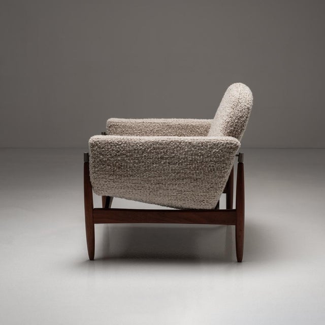Crafted with timeless Scandinavian design, this teak wood armchair is a statement of both elegance and comfort. The...