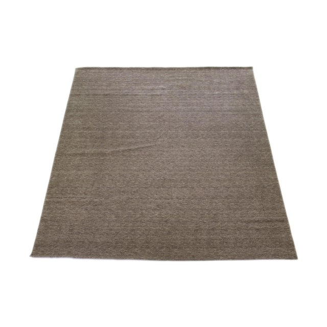 This modern Gabbeh rug, hand-loomed with exceptional care, embodies elegance and contemporary style with its minimalist...