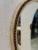 A unique Italian mid-century wall mirror featuring an organic, freeform shape framed with a rope-style trim. Its fluid...