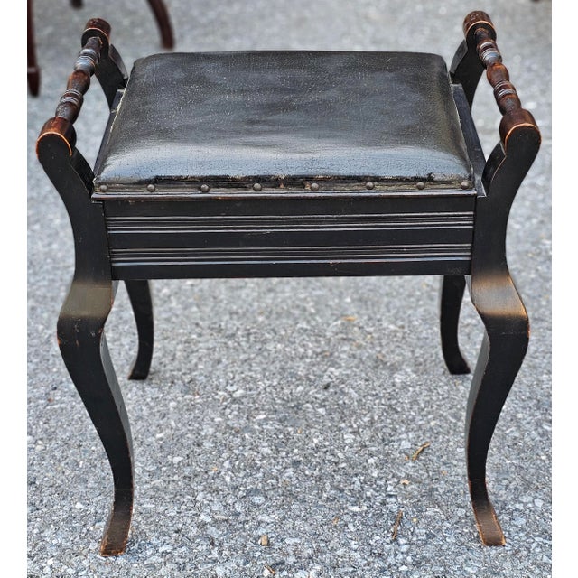 Early 20th Century Carved Wood Accent piano or vanity Storage Bench with vinyl seat..Measures 21" in width, 15.5" in depth...