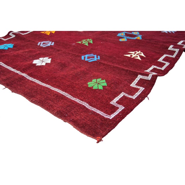 Handwoven Moroccan Berber kilim with a design of natural symbols and geometric shapes. This gorgeous accent ships within...